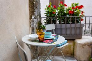 a table with two cups and two glasses on it at Picalof Apartments in Malcesine