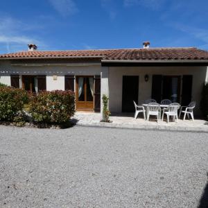 a house with chairs and a table in front of it at Large Spacious House In Fréjus in Fréjus
