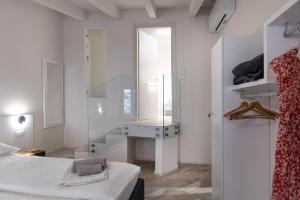 a white room with a sink and a mirror at Picalof Apartments in Malcesine