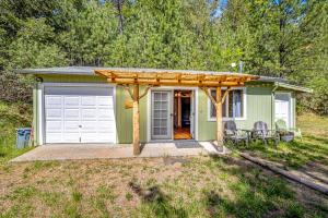 a green tiny house with a white garage at Yosemite Mountain Cottage in Groveland