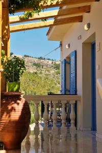 a balcony with a view of a hill at REMVI Apartments Assos in Asos