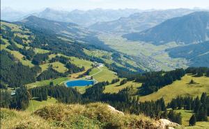 a view of a valley with a lake and mountains at Haus Hirzinger in Brixen im Thale