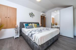 a bedroom with a large bed and a mirror at Villa Ane in Čelopeci +23 photos