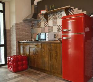 a red refrigerator in a kitchen with a counter at Апартаменты ПРЕМЬЕР in Kamianets-Podilskyi