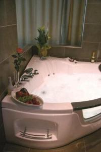 a bathroom with a sink with a bowl of fruit in it at Hotel Restaurant Pusswald in Hartberg +18 photos