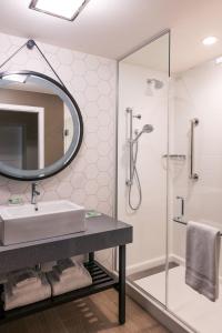 a bathroom with a shower, sink, and toilet at Holiday Inn & Suites Nashville Downtown Broadway in Nashville