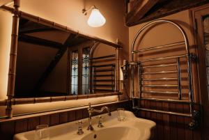 a bathroom with a sink and a mirror at La Maison De Lucie in Honfleur