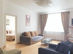 a living room with a couch and a bed at City Inn Riga Apartment, Town Hall view with parking in Rīga