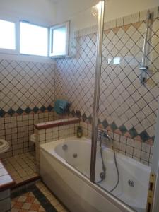 a bathroom with a bath tub and a shower at La finestra sul mare in Lido di Ostia +31 photos