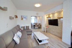 a living room with a couch and a tv at Francesca Apartment in Bibinje