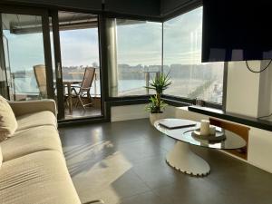 a living room with a couch and a table at Luxury boutique playa Silgar in Sanxenxo