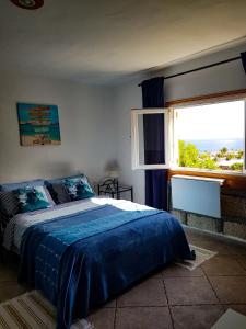 a bedroom with a bed and a large window at Apartmento Tabares in Tejina