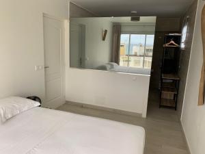 a bedroom with a bed and a large mirror at Le Roof Top in Le Gosier
