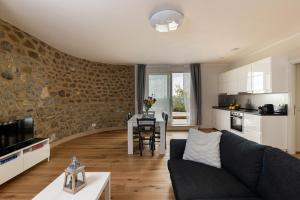 a living room with a couch and a table at Podere Belsogno in Montalcino +29 photos