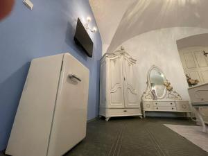 a kitchen with a white refrigerator and a mirror at Dvoulůžkový pokoj Blue Grace na zámku in Česká Kamenice
