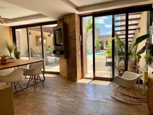 a dining room with a table and chairs and sliding glass doors at Casalaabuelaines in Corral de Calatrava