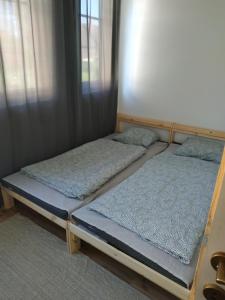 two bunk beds in a room with a window at Vivienne Apartment in Zamárdi
