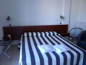 Postel nebo postele na pokoji v ubytování Hotel L'Ancora