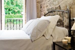 A bed or beds in a room at Sete Artes by Como en Casa