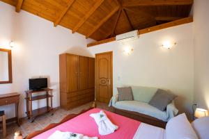 a living room with a bed and a couch at Delphinus Villa Nefeli in Agios Nikitas