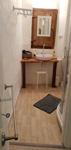 a bathroom with a sink and a mirror at La Porte Bleue in Saint-Antonin