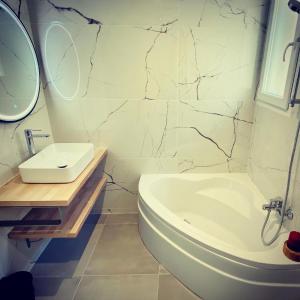 a bathroom with a sink and a toilet and a mirror at "ZEN" 100m de la plage avec parking, vue mer et vue montagne in Canet-en-Roussillon