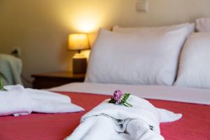 a hotel room with two beds with towels at Delphinus Villa Nefeli in Agios Nikitas