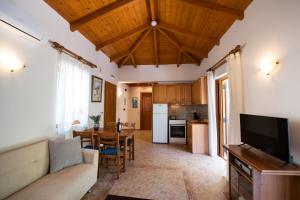 a living room with a couch and a table at Delphinus Villa Nefeli in Agios Nikitas