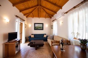 a living room with a couch and a table at Delphinus Villa Nefeli in Agios Nikitas