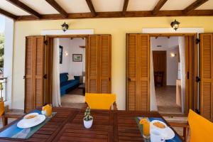 a dining room with a table and chairs at Delphinus Villa Nefeli in Agios Nikitas