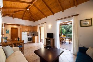 a living room with a couch and a table at Delphinus Villa Nefeli in Agios Nikitas