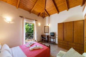 a bedroom with a bed and a desk and a window at Delphinus Villa Nefeli in Agios Nikitas +37 photos