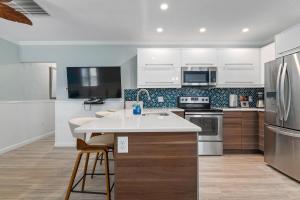 a kitchen with white cabinets and a white counter top at Suntan Terrace in Nokomis