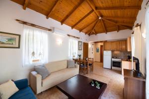 a living room with a couch and a table at Delphinus Villa Nefeli in Agios Nikitas