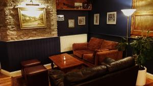 a living room with a couch and a table at Jacobs Ladder Inn in Falmouth