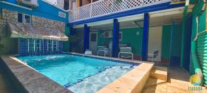 a swimming pool in front of a house at A1 Apartments Aruba in Oranjestad