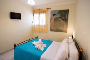 a bedroom with a bed with towels on it at Delphinus Villa Nefeli in Agios Nikitas