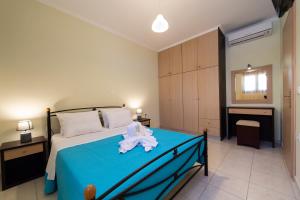 a bedroom with a bed with a towel on it at Delphinus Villa Nefeli in Agios Nikitas