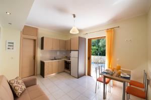 a kitchen and a living room with a table at Delphinus Villa Nefeli in Agios Nikitas