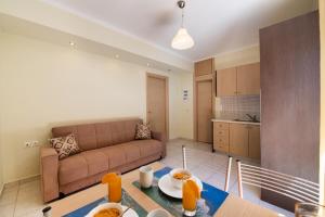 a living room with a couch and a table at Delphinus Villa Nefeli in Agios Nikitas
