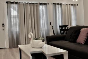 a living room with a swan on a coffee table at Charming Apartment in Santa Monica