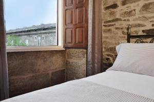 A bed or beds in a room at Sete Artes by Como en Casa