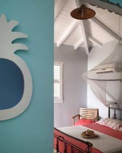 a room with a bed and a blue wall at Bungalow cocodile in Sainte-Anne