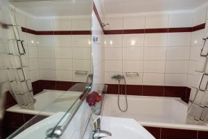 a bathroom with a shower and a sink and a tub at Delphinus Villa Nefeli in Agios Nikitas