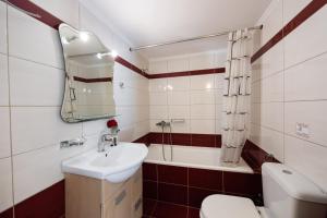 a bathroom with a sink and a toilet and a tub at Delphinus Villa Nefeli in Agios Nikitas