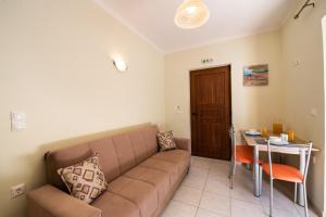 a living room with a couch and a table at Delphinus Villa Nefeli in Agios Nikitas
