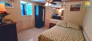 a bedroom with a bed and a blue door at A1 Apartments Aruba in Oranjestad