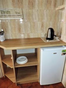 a kitchen with a wooden counter top and a refrigerator at Jacek i Agatka in Ustka
