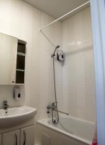 a bathroom with a shower and a tub and a sink at Апартаменты в Одессе in Odesa