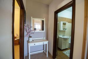 a bathroom with a sink and a mirror at Nicoles Houses Arillas Corfu in Arillas +42 photos